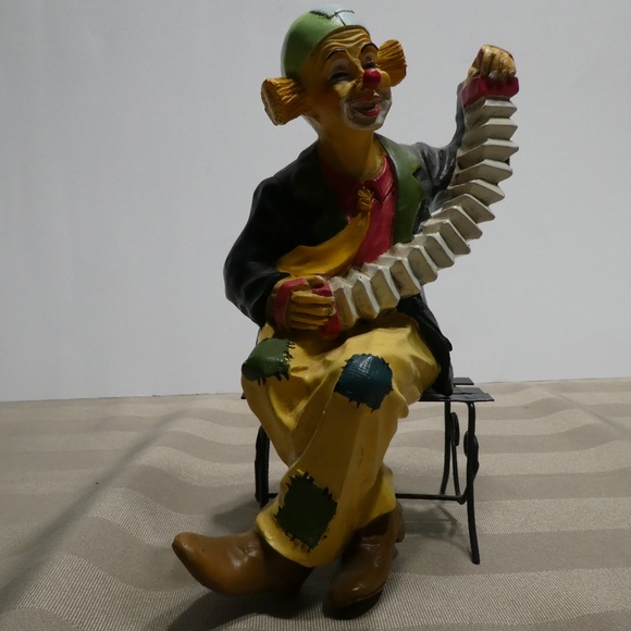 CLOWN figurine Musical Instrument sitting on bench